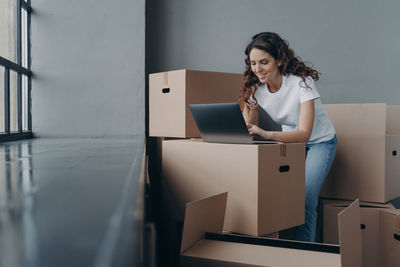 Portrait of young woman holding box