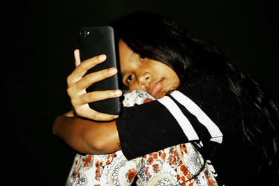 Portrait of girl using mobile phone