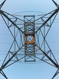 Low angle view of electricity pylon against clear sky