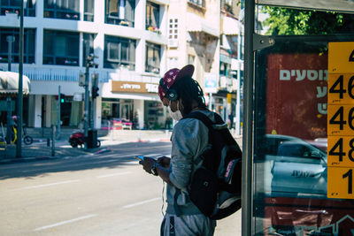 Man standing on street in city