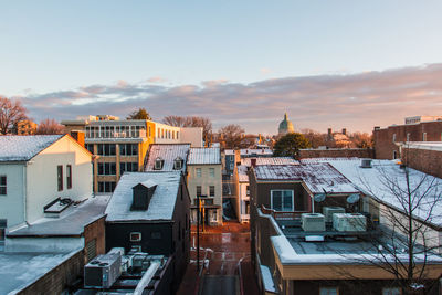 High angle view of buildings in town against sky