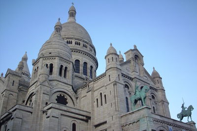 Low angle view of historic building against clear blue sky