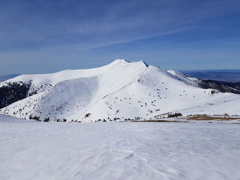 Scenic view of snow covered mountain against sky