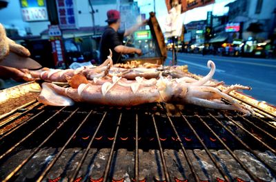 Calamari fish on barbecue grill at stalls