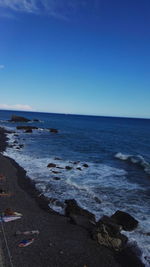 Scenic view of sea against clear blue sky