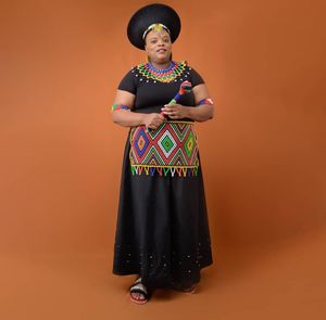 Portrait of woman standing against yellow background