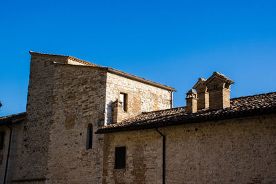 Low angle view of building against clear blue sky