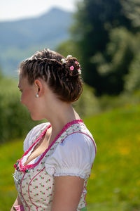 Girl looking away while standing on field