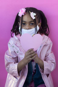 Portrait of a girl holding pink flower