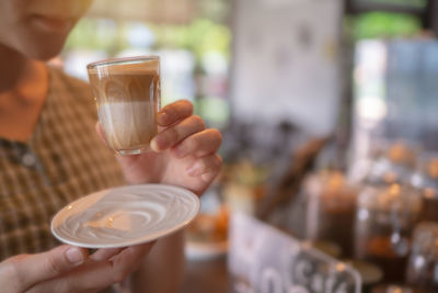 Beautiful speculoos latte with milk in a glass ,cafe background.