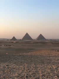 Scenic view of desert against sky during sunset