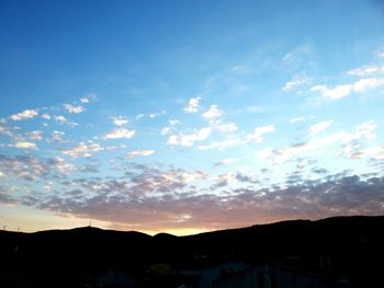 Silhouette of landscape against cloudy sky