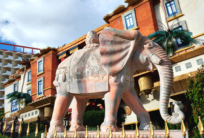 Low angle view of statue against building