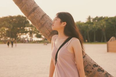 Young woman standing at beach