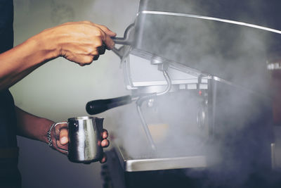 Man pouring coffee in glass