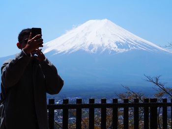 Man photographing against mt fuji