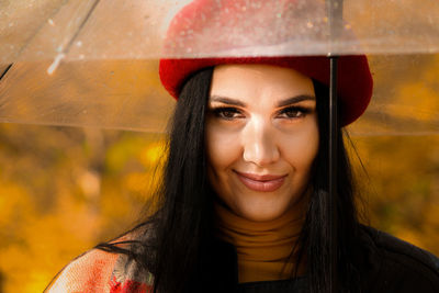 Portrait of smiling young woman in hat