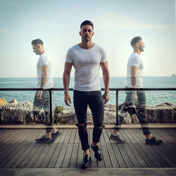 Multiple exposure of man on promenade against sky