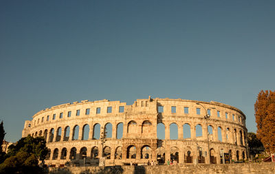 Low angle view of historical building against sky the ancient arenas of pula