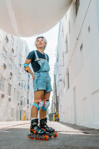 Woman wearing kneepad skating on road