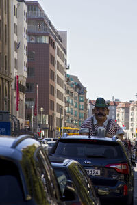 Man in city against clear sky