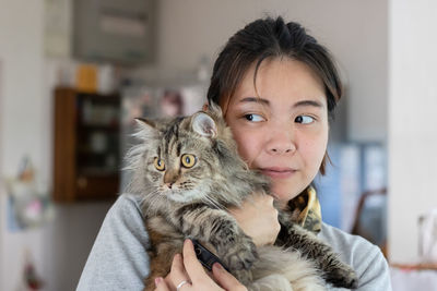 Close-up of woman holding cat