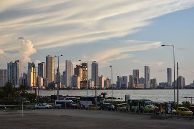 View of cityscape against cloudy sky