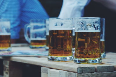 Close-up of beer glasses on table