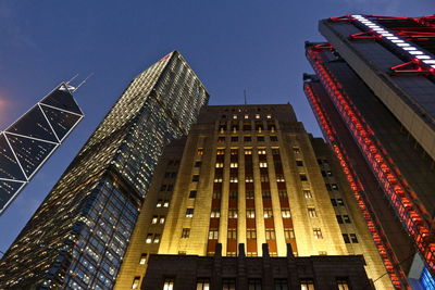 Low angle view of illuminated buildings against sky at dusk