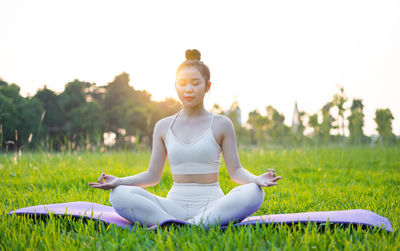 Portrait of young woman sitting on grass