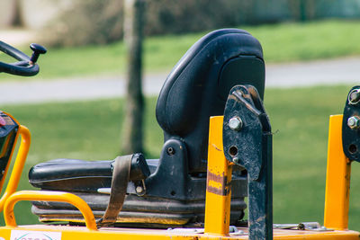 Close-up of yellow machine in park