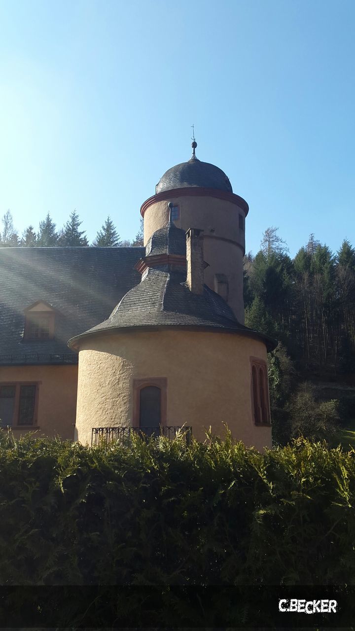 clear sky, building exterior, architecture, built structure, tree, copy space, blue, plant, low angle view, day, growth, green color, outdoors, religion, dome, no people, travel destinations, nature, sunlight, grass