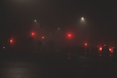 Illuminated road against sky at night