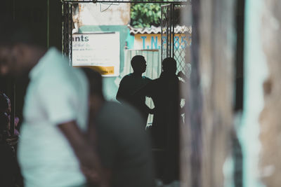 Rear view of people looking at camera