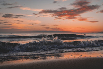 Scenic view of beach against sky during sunset