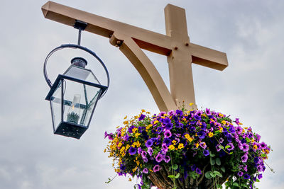 Low angle view of cross against sky