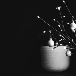 Close-up of illuminated lighting equipment against black background