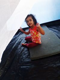 Portrait of cute girl sitting in tent