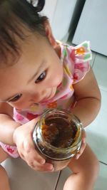 High angle view portrait of girl drinking glass