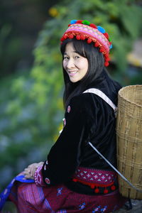 Portrait of smiling woman sitting outdoors