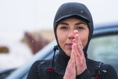 Young woman preparing for winter surfing in snow