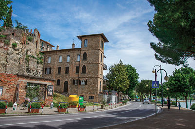 View of promenade in a village at the shore of lake trasimeno, italy.