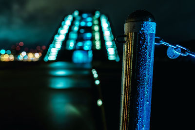 Close-up of illuminated metallic structure at night