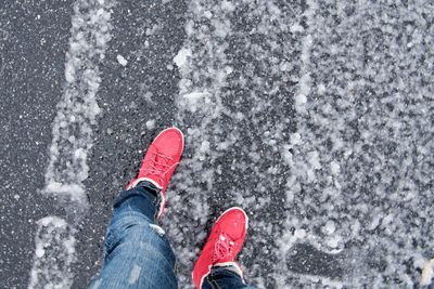 Low section of man standing on road