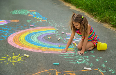 High angle view of girl drawing on field