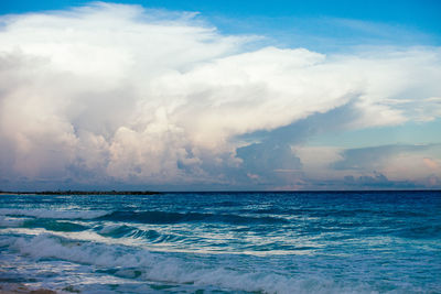 Scenic view of sea against cloudy sky