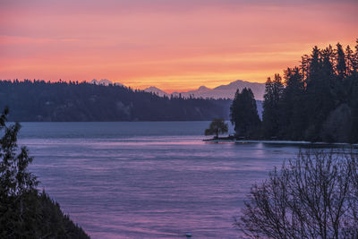 Scenic view of lake against romantic sky at sunset