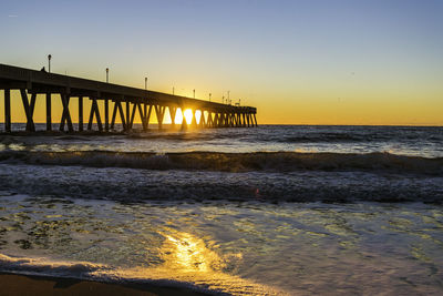 Scenic view of sea against clear sky during sunset