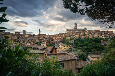 High angle shot of townscape against sky, leaf framed, siena, italy