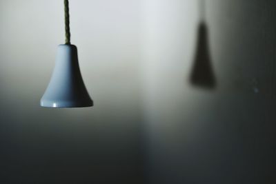 Pendant light hanging against wall